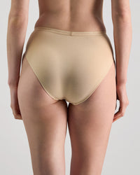 Model wears Body Cotton High Cut Brief in NATURAL. On body back view
