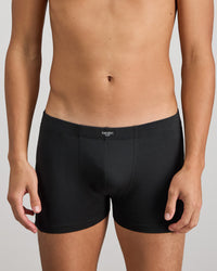 Model wears Cotton Stretch Mens Trunk in BLACK. On body front view