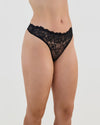 Model wears All Lacey Thong in BLACK. On body side view