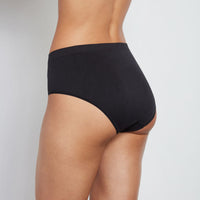 Model wears Seamless Full Brief in BLACK. On body back view