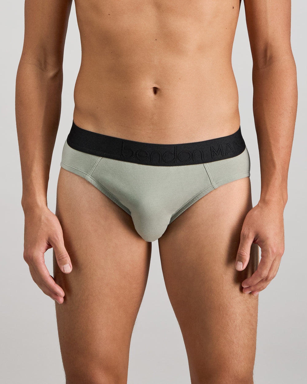 Model wears Everyday Essential Mens Brief in ICEBERG GREEN. On body front view