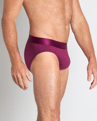 Model wears Bamboo Mens Brief in MAGENTA PURPLE. On body side view