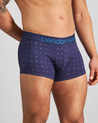 Model wears Retros Print Mens Trunk in INKY SPOT PRINT. On body side view