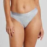 Model wears Cotton Logo Thong in GREY MARL. On body front view