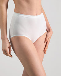 Model wears Freedom Full Brief in WHITE. On body side view