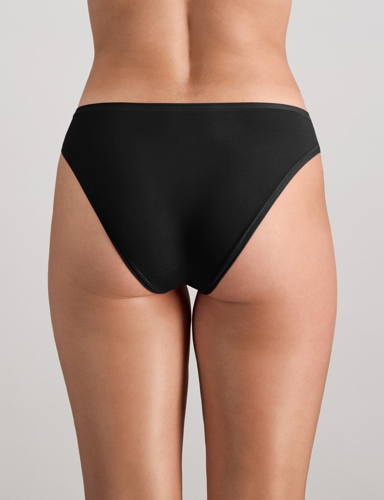 Model wears Extra-Ordinary Bikini in BLACK. On body back view