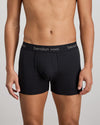 Model wears Cotton Classics Mens Trunk in BLACK. On body front view