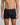 Model wears Cotton Classics Mens Trunk in BLACK. On body front view