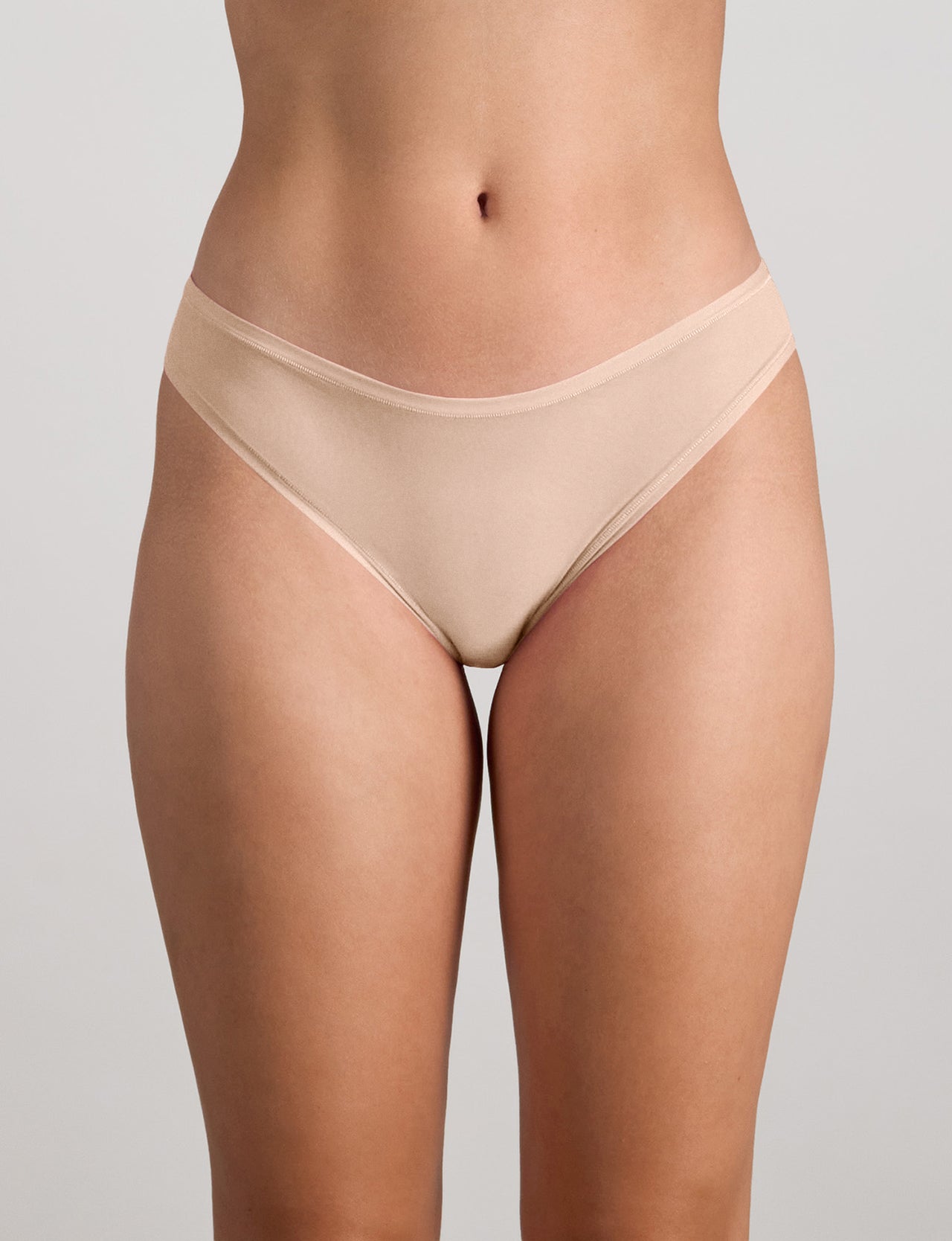 Model wears Extra-Ordinary Bikini in LATTE. On body front view