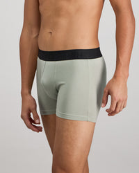 Model wears Everyday Essential Mens Trunk in ICEBERG GREEN. On body side view