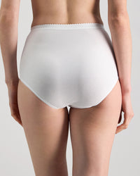 Model wears Freedom Full Brief in WHITE. On body back view