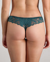 Model wears Margot Estelle Thong in MEDITERRANEA. On body back view