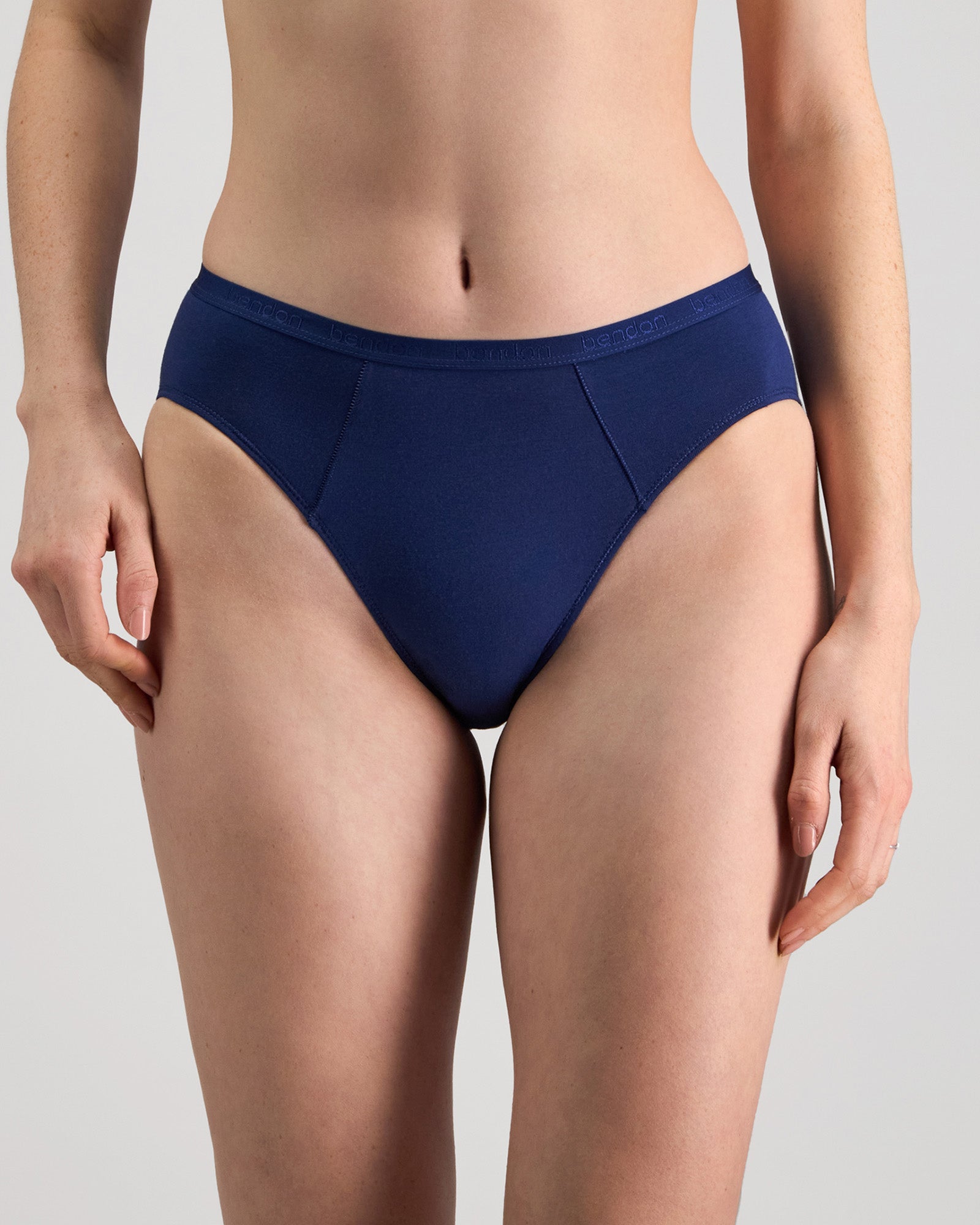 Model wears Body Cotton High Cut Brief in Medieval Blue. On body front view
