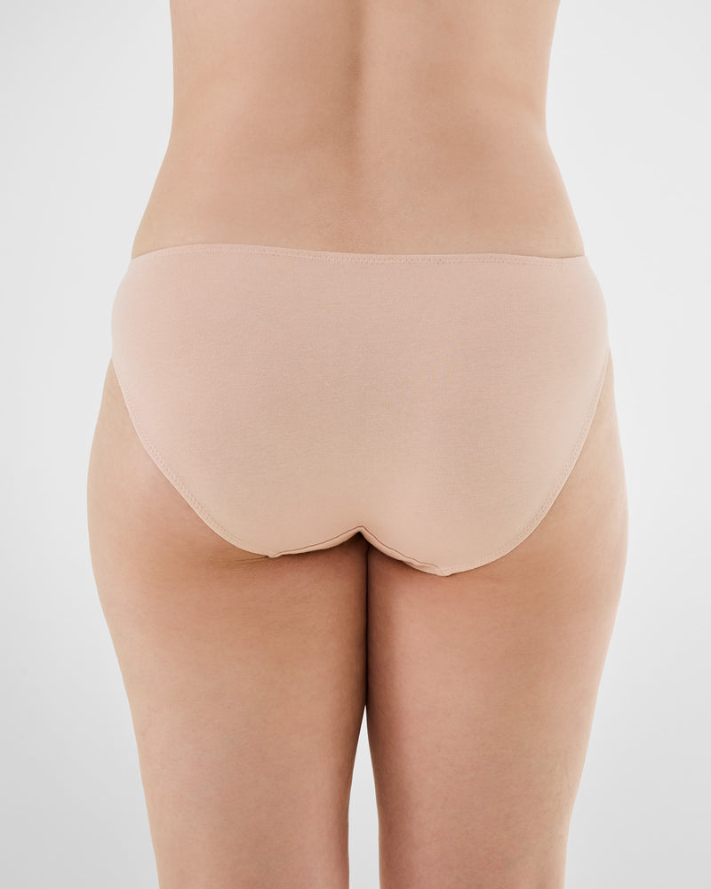 Model wears Embrace Bikini in LATTE. On body back view