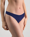 Model wears Extra-Ordinary Thong in Medieval Blue. On body side view
