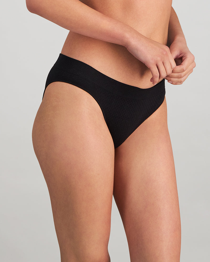 Model wears Play Bikini in BLACK. On body side view