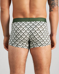 Model wears Retros Print Mens Trunk in ART DECO TILE PRINT. On body back view