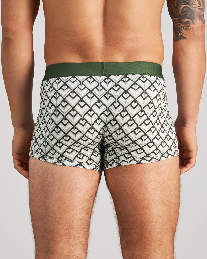 Model wears Retros Print Mens Trunk in ART DECO TILE PRINT. On body back view