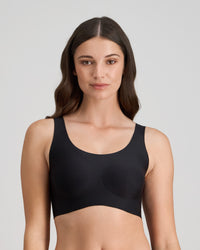 Model wears Comfit Collection Crop Top in BLACK. On body front view