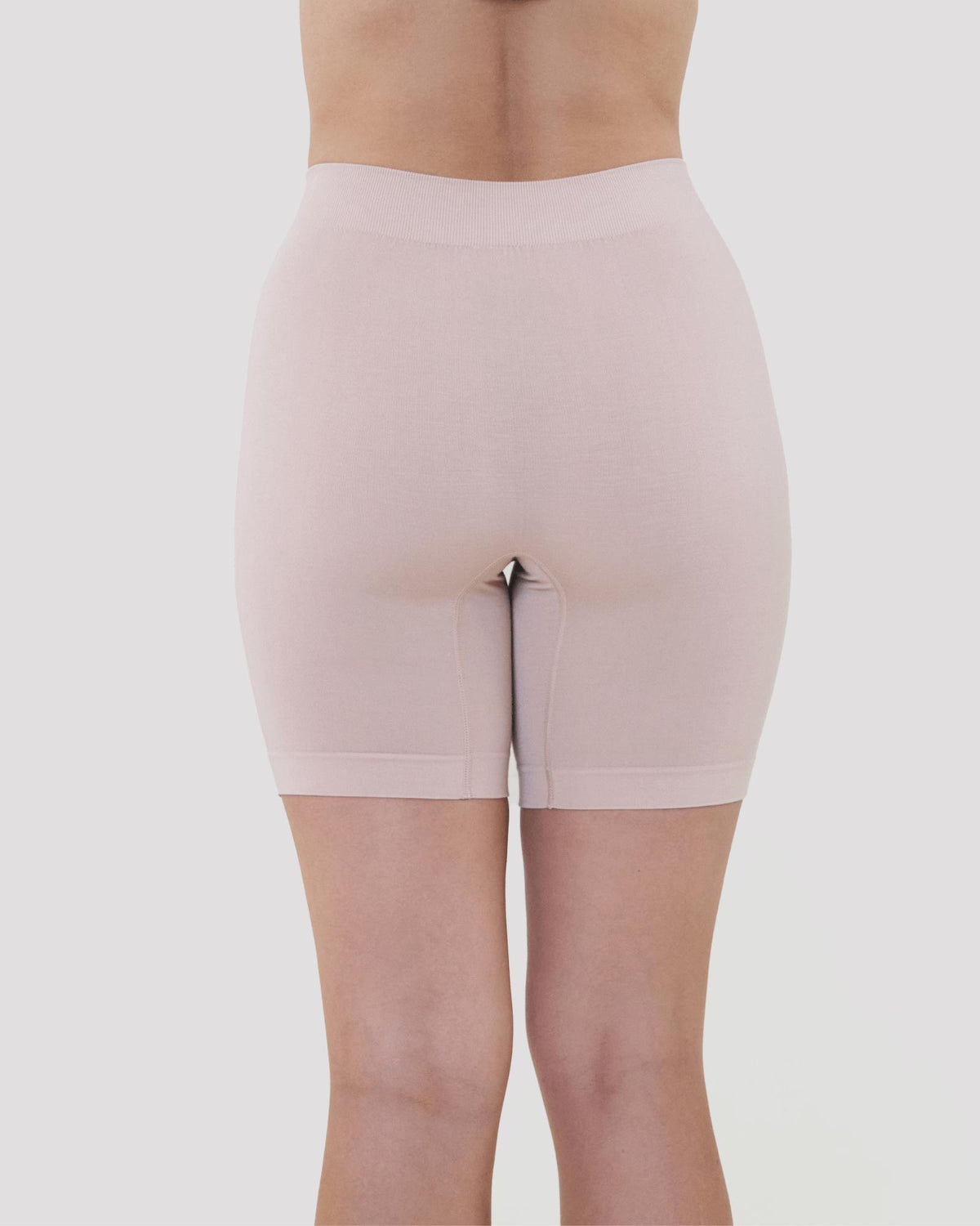 Model wears Smoothing Bodywear Chafer Short in CARAMEL. On body back view