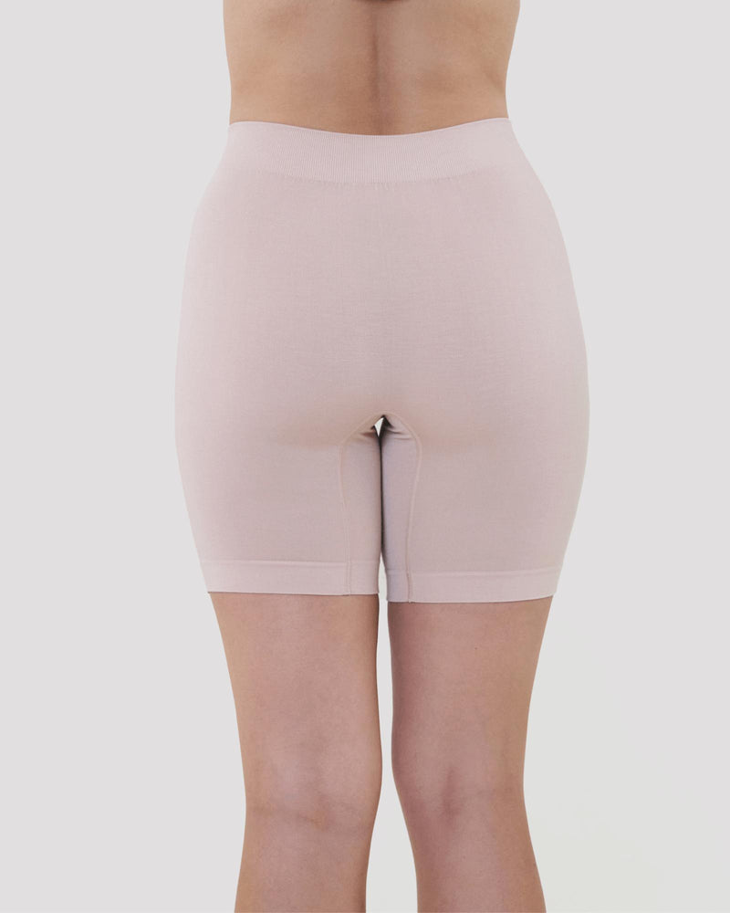 Model wears Smoothing Bodywear Chafer Short in CARAMEL. On body back view