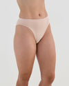 Model wears Seamless Soft High Cut Brief in LATTE. On body side view