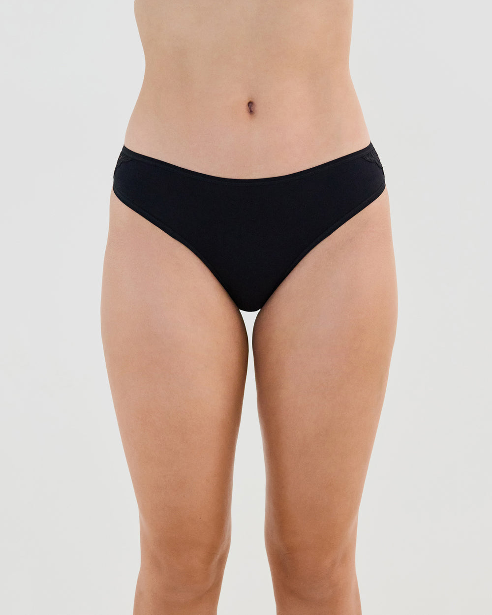 Model wears Cotton And Lace Bikini in BLACK. On body front view