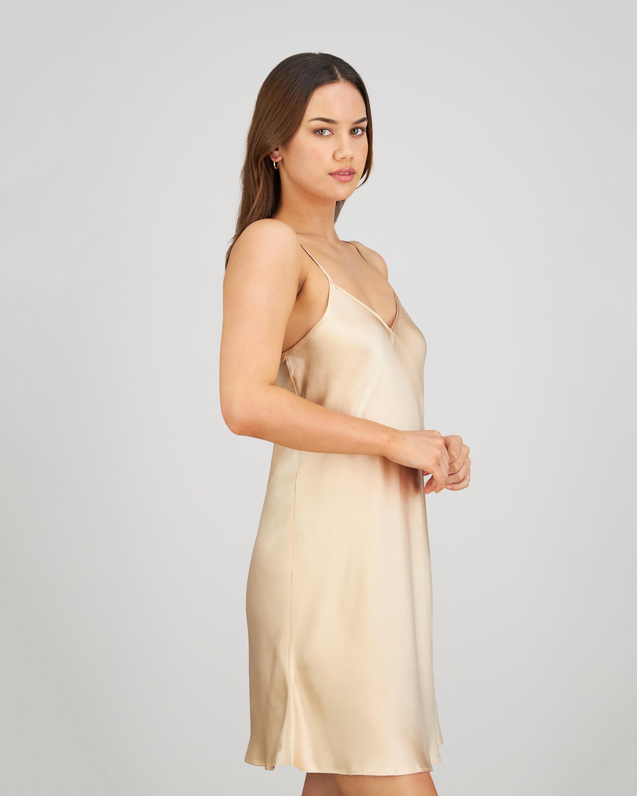 Model wears Silk Brilliance Chemise in CHAMPAGNE. On body side view