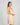Model wears Silk Brilliance Chemise in CHAMPAGNE. On body side view