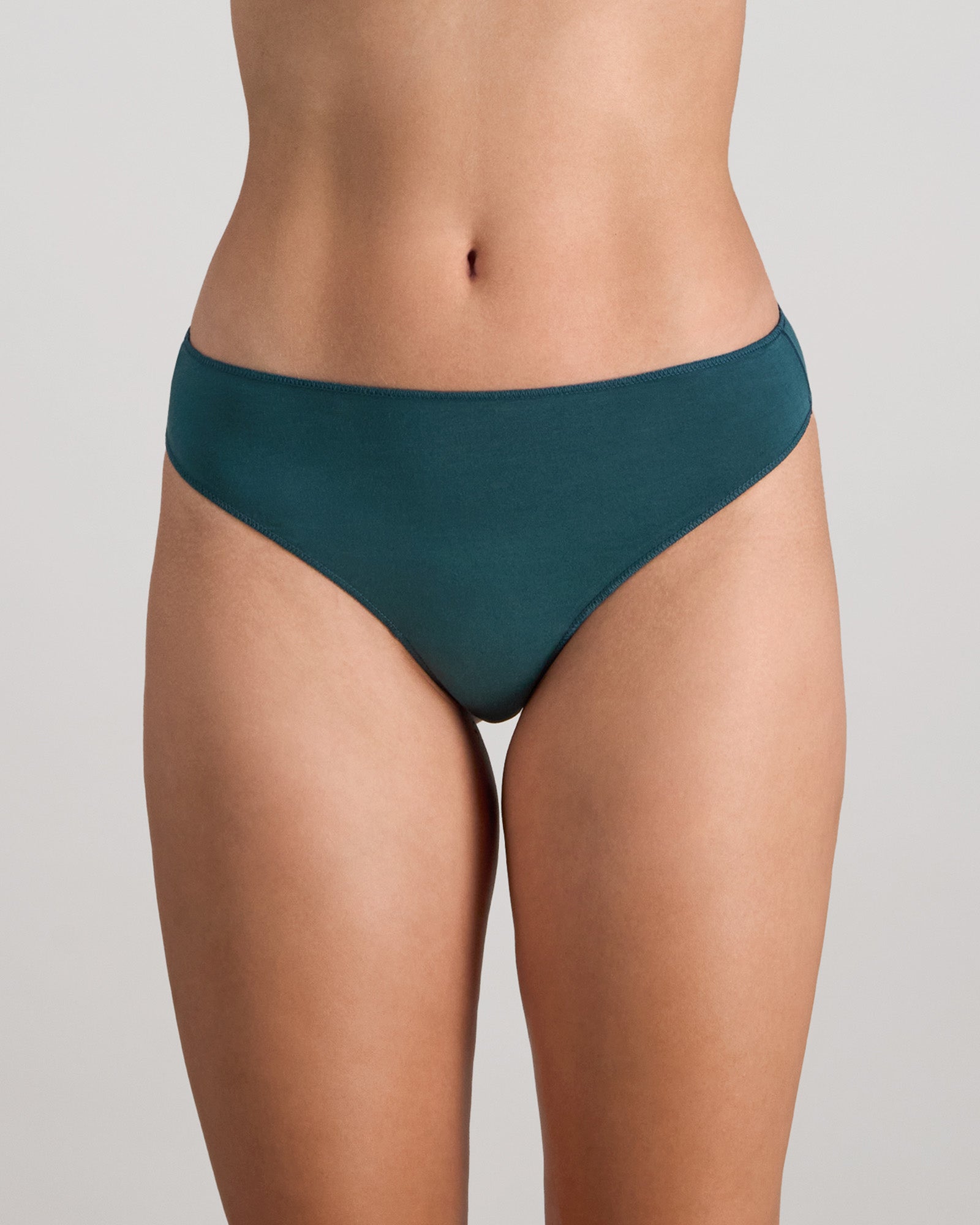 Model wears Au Naturel Thong in MEDITERRANEA. On body front view