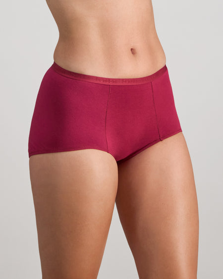Model wears Body Cotton Full Brief in BEAUJOLAIS. On body side view