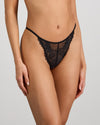 Model wears Midnight Magic Thong in BLACK. On body side view