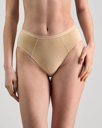 Model wears Body Cotton High Cut Brief in NATURAL. On body front view