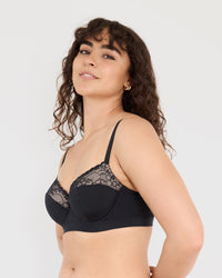 Model wears Castaway Contour Long Line Bra in BLACK. On body side view