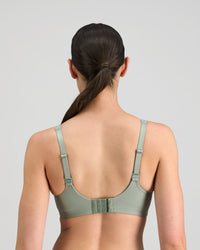 Model wears Power Underwire Bra in ICEBERG GREEN. On body back view