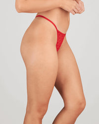 Model wears Wrapped In Bows Thong in SALSA. On body side view
