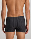 Model wears Cotton Stretch Mens Trunk in BLACK PINSTRIPE. On body back view