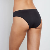 Model wears Seamless Bikini in BLACK. On body back view