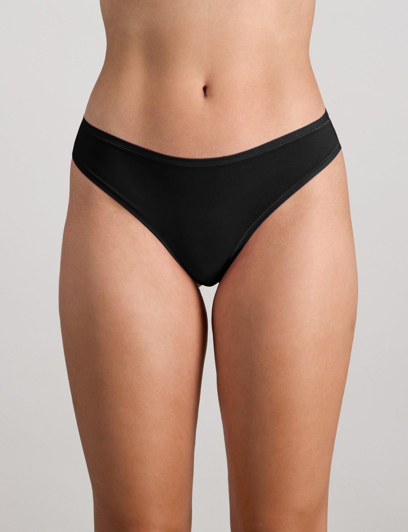 Model wears Extra-Ordinary Thong in BLACK. On body front view