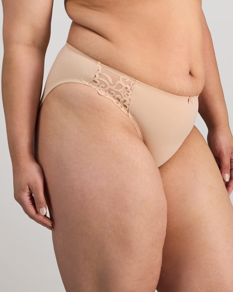 Model wears Coral High Cut Brief in LATTE. On body side view