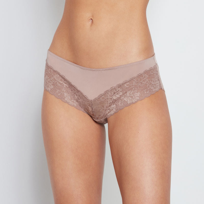 Model wears Lace Trim Brazilian in MOCHA. On body front view