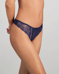 Model wears Sofia Thong in Medieval Blue. On body side view