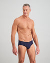 Model wears High Tech Cotton Mens Brief in PEACOAT. On body side view