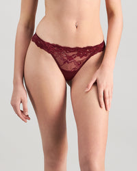 Model wears My Fit Lace Thong in WINDSOR WINE. On body front view