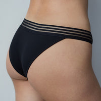 Model wears Stripe Elastic & Papertouch Tanga in BLACK. On body back view
