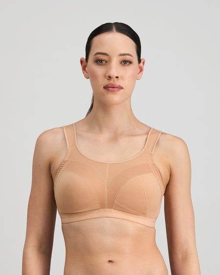 Model wears Stamina Wire Free Bra in LATTE. On body front view