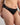 Model wears Coral High Cut Brief in BLACK. On body side view