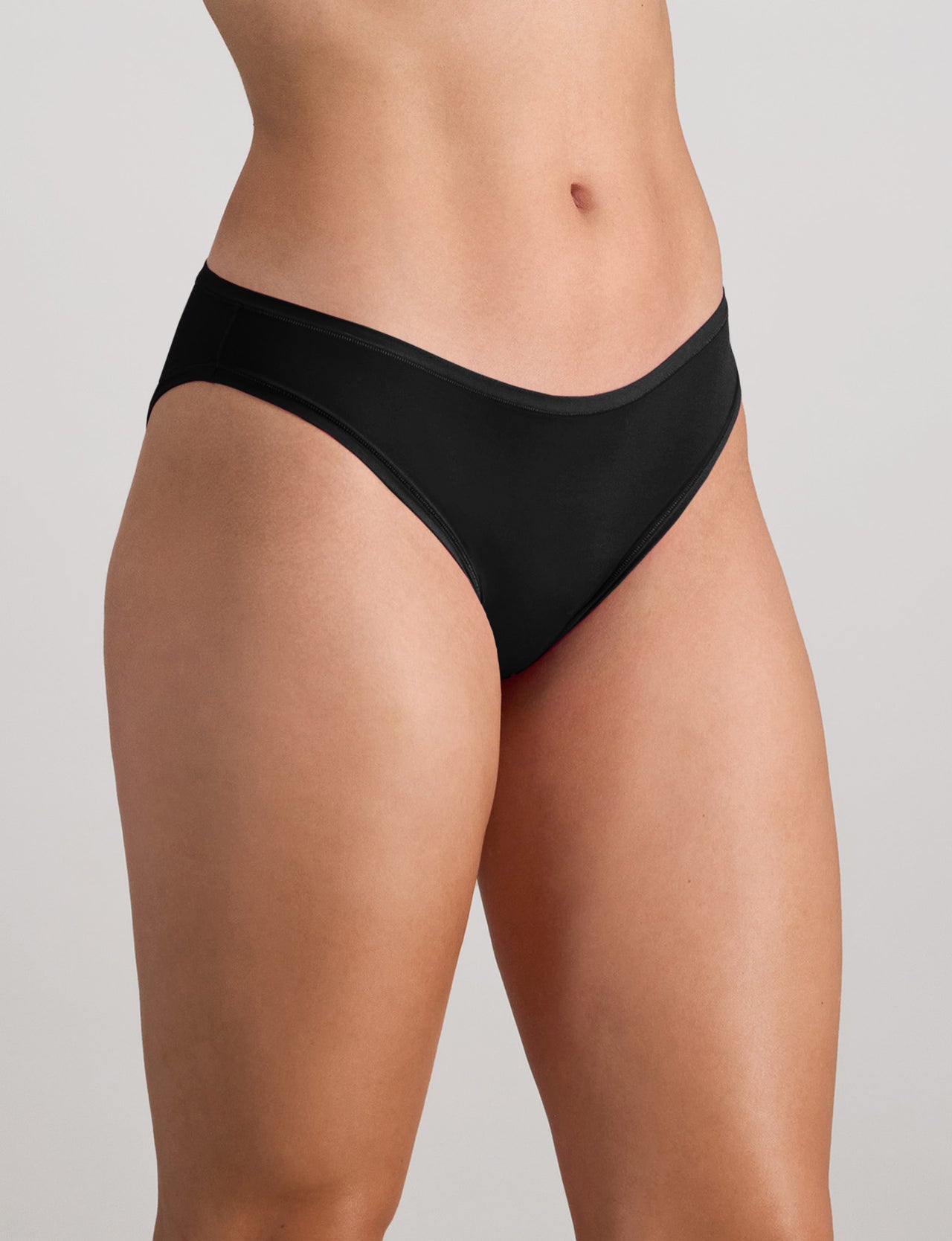 Model wears Extra-Ordinary Bikini in BLACK. On body side view