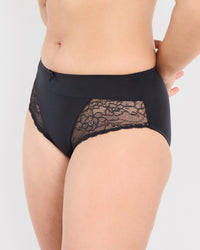 Model wears Castaway Midi in BLACK. On body side view