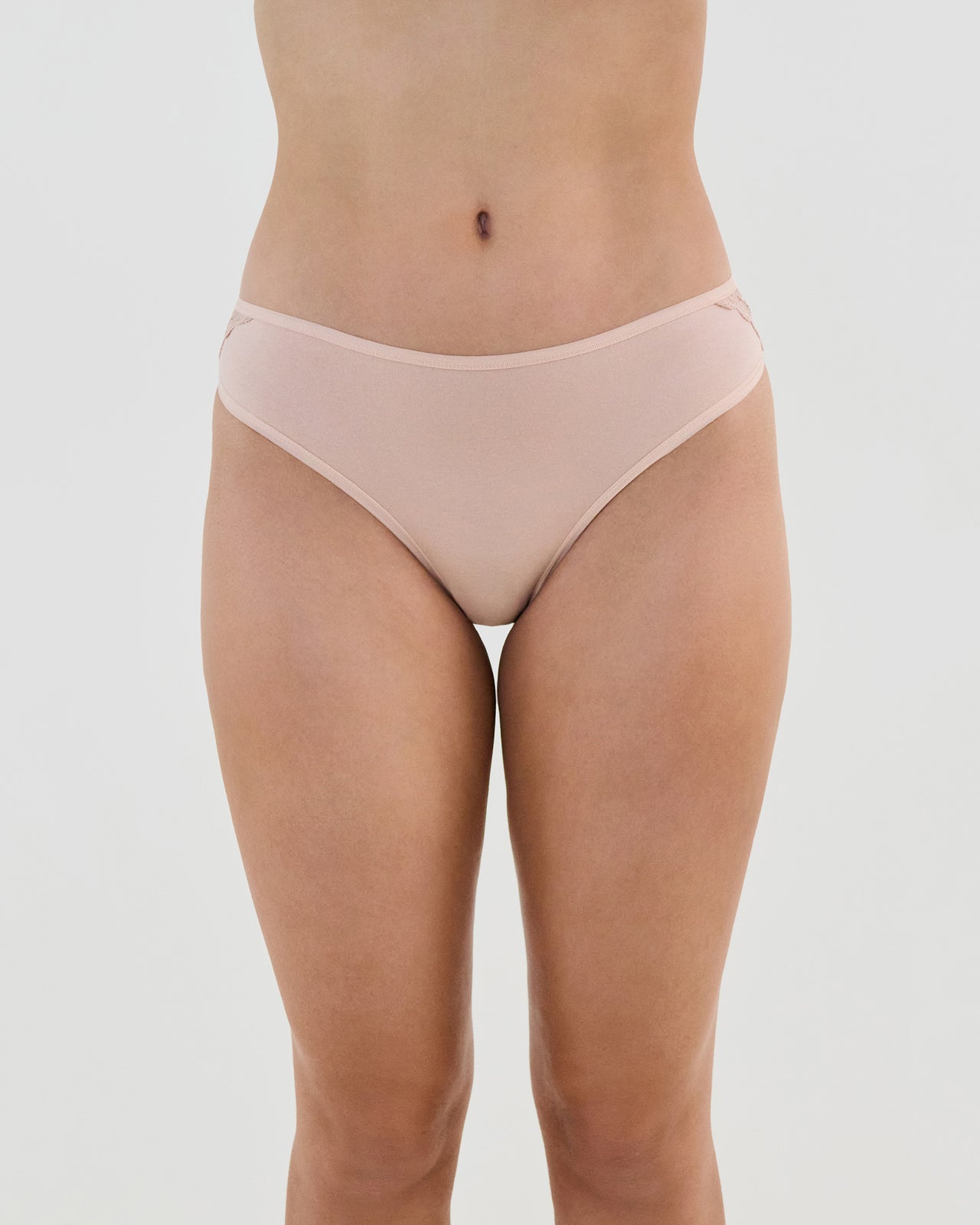 Model wears Cotton And Lace Bikini in LATTE. On body front view